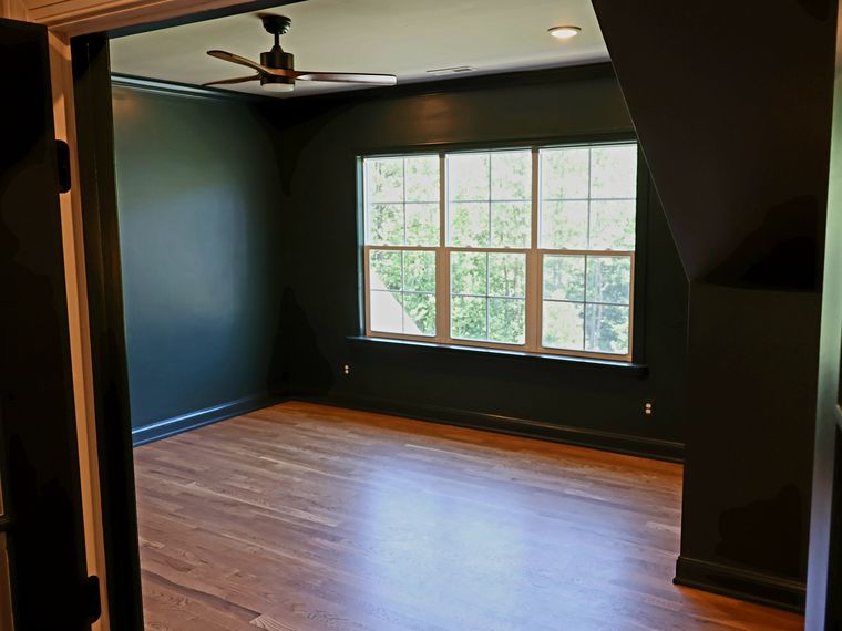Finished attic conversion with dark walls and hardwood floors in Chapel Hill, NC